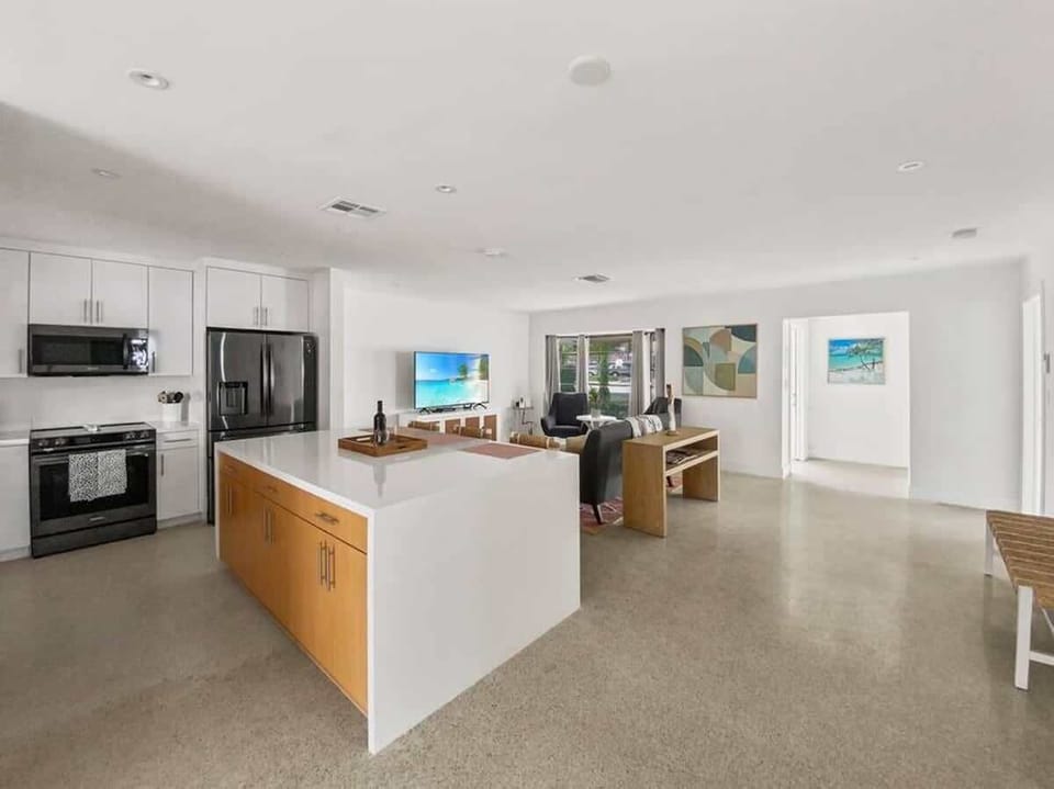 The kitchen is stocked with a full set of appliances including a refrigerator and basic kitchen utensils. 