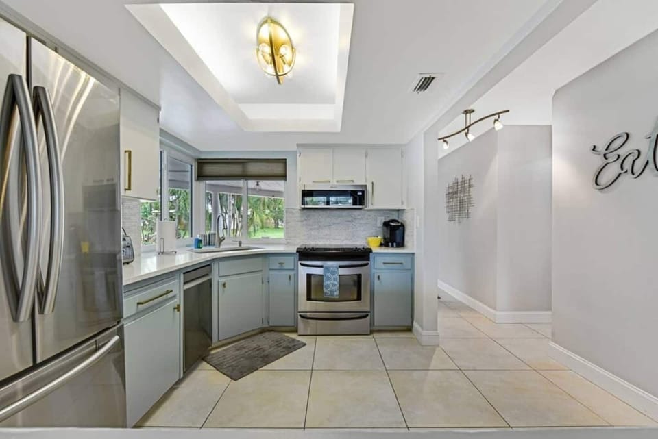 The kitchen is stocked with a full set of appliances including a refrigerator and basic kitchen utensils. 