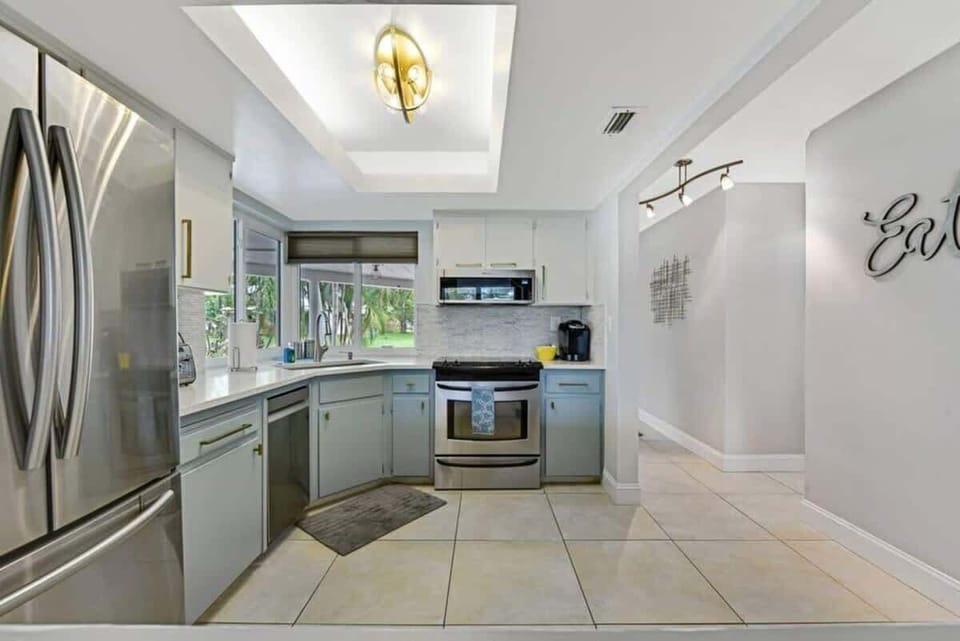 The kitchen is stocked with a full set of appliances including a refrigerator and basic kitchen utensils. 