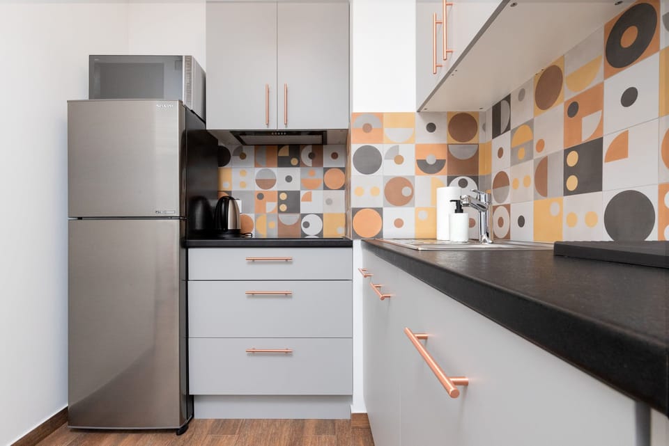 A fully equipped kitchen featuring modern appliances and a charming design.
