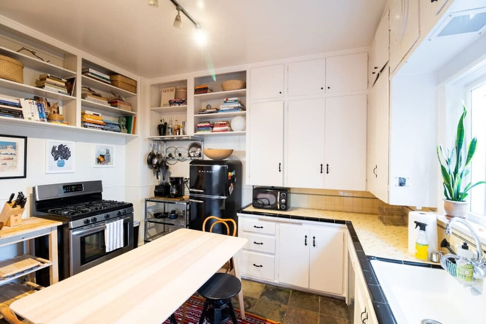 Fully stocked kitchen with microwave, stove, fridge, and dishwasher. The cabinets are filled with salt, paper, and oil, as well as lots of other cooking spices or anything you would need.