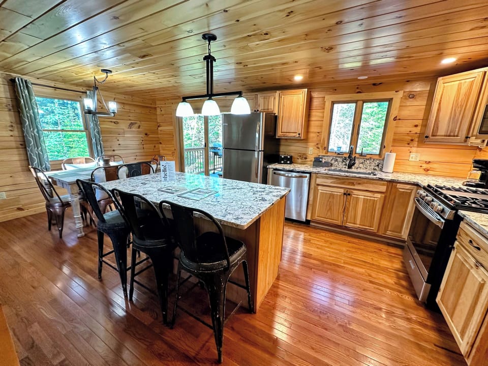 The fully equipped kitchen has stainless steel appliances and granite countertops.