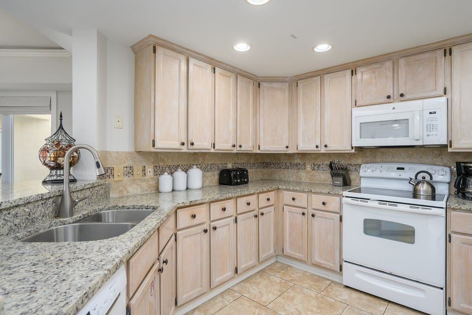 Full-size appliances and a wide prep area make group meals simple, while the open sightlines to the living space keep everyone connected.