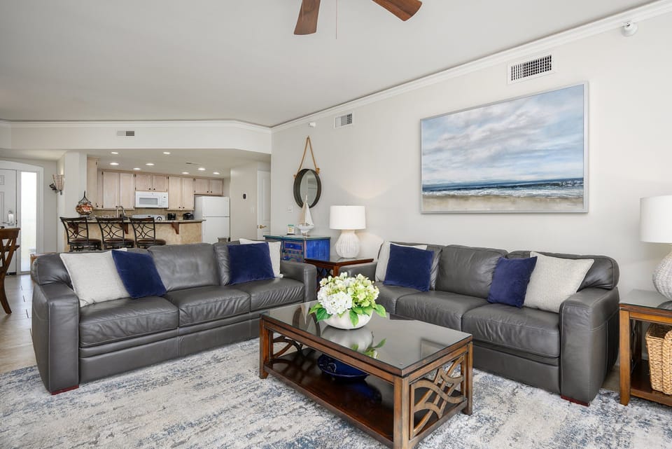 Plush seating arranged around a central coffee table and plenty of natural light streaming in from the sliding doors.