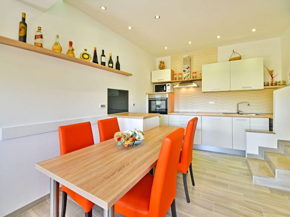 Table, Property, Furniture, Cabinetry, Chair, Orange, Wood, Interior Design, Countertop, Kitchen