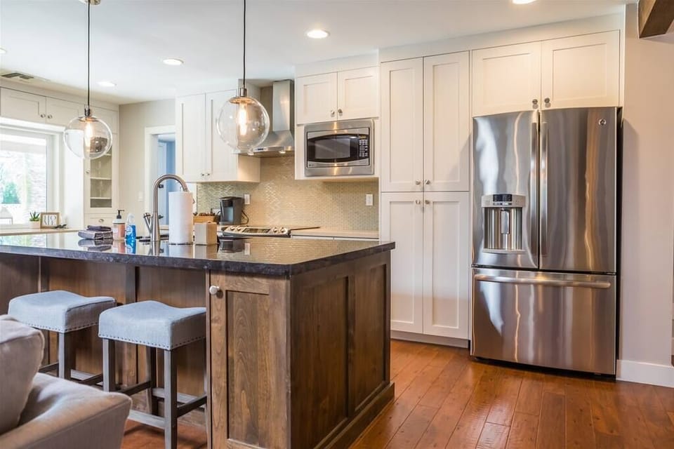 Fully stocked kitchen with stainless appliances and granite counters