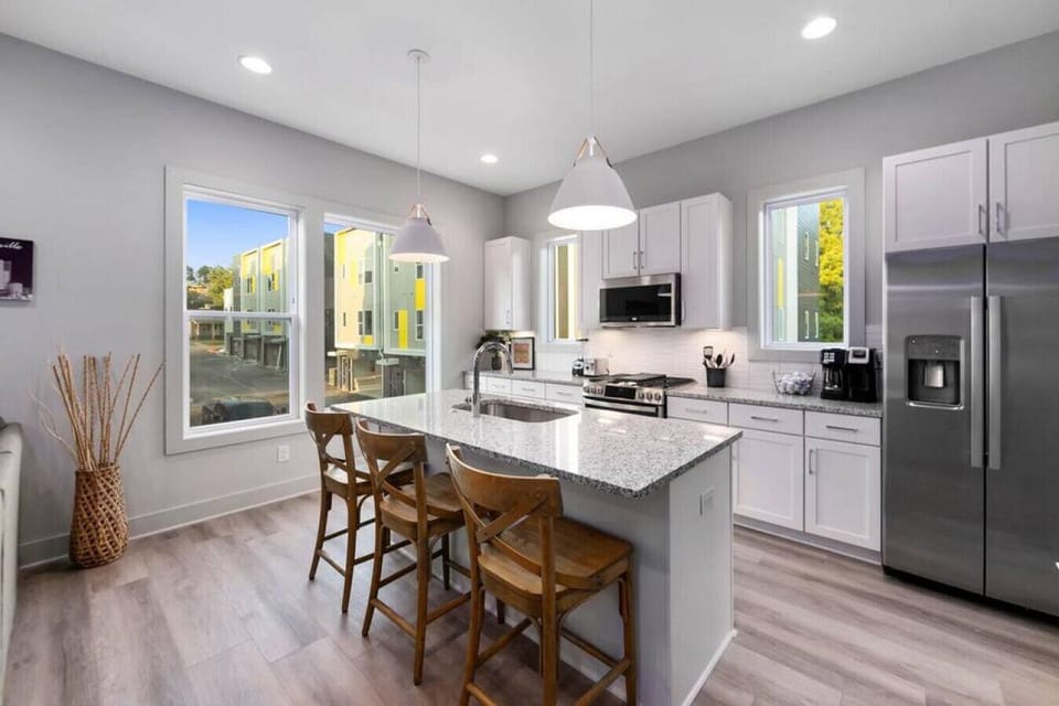 Kitchen with island stocked with pots, pans, and utensils