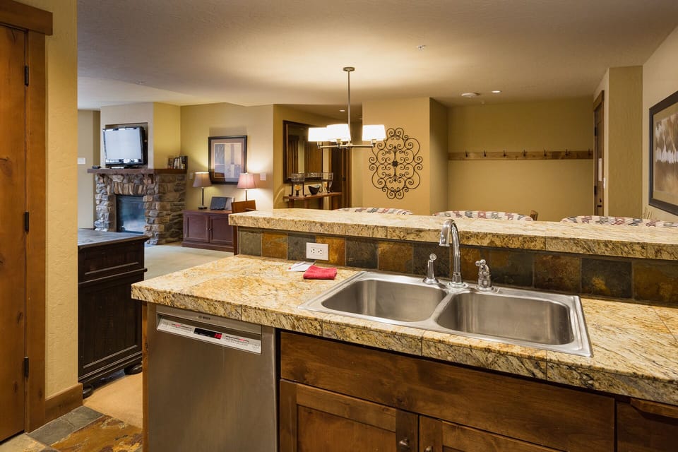 Kitchen and bar area. Fully stocked with cookware and dishware.