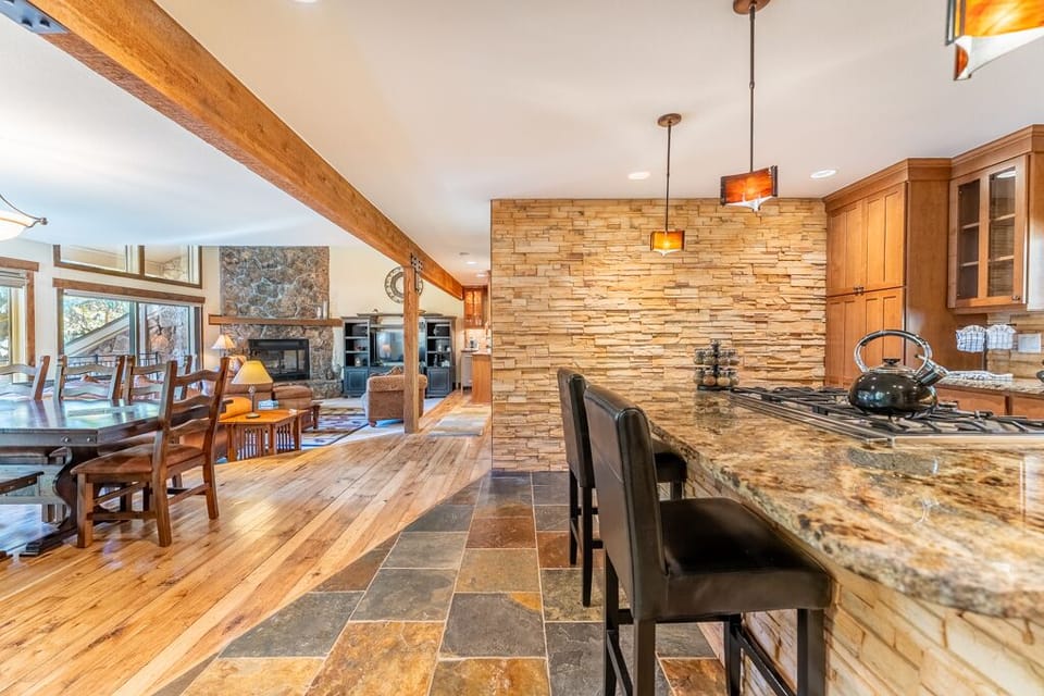 Your gourmet kitchen invites culinary adventures with granite counters, stone backsplash, and gleaming appliances—perfect for memorable meals together.