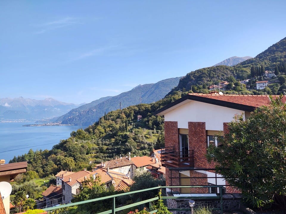 Sky, Mountain, Daytime, Building, Water, Tree, Plant, Highland, House, Wood