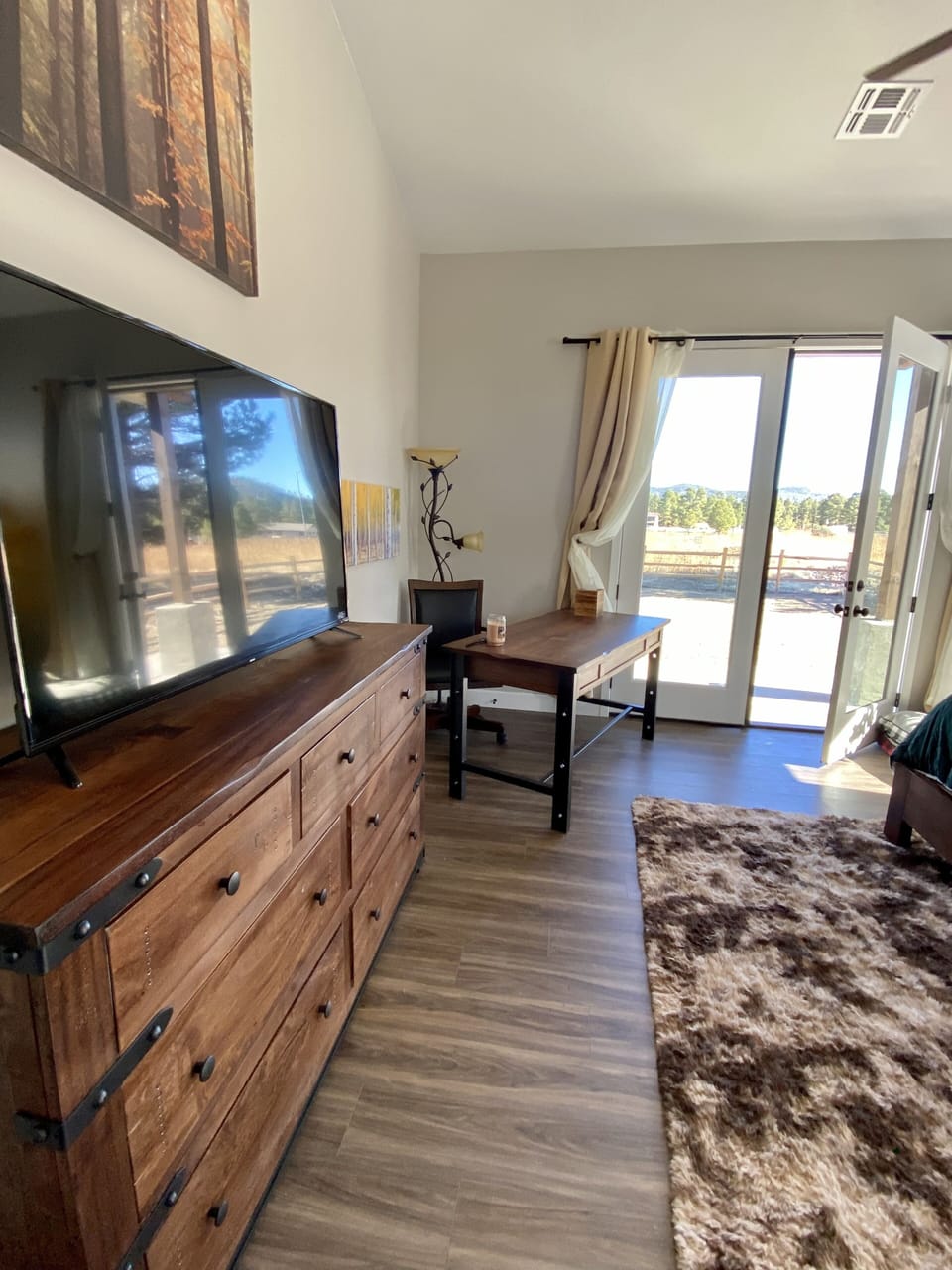 Master 1 with 65" TV and desk; French double doors leading to back yard