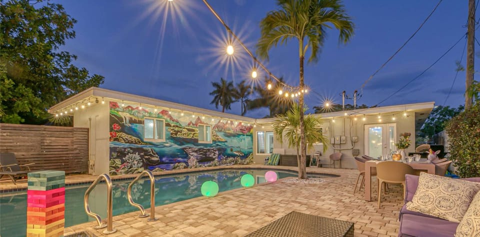 Spacious fenced-in back yard Oasis, heated pool, BBQ Grill, dining table for 10, lounge chairs, and patio table for lounging and entertaining. 