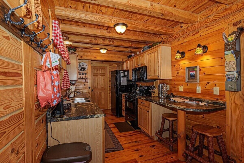 This open kitchen includes rustic cabinetry and charming seasonal touches, ideal for preparing meals after outdoor mountain adventures.