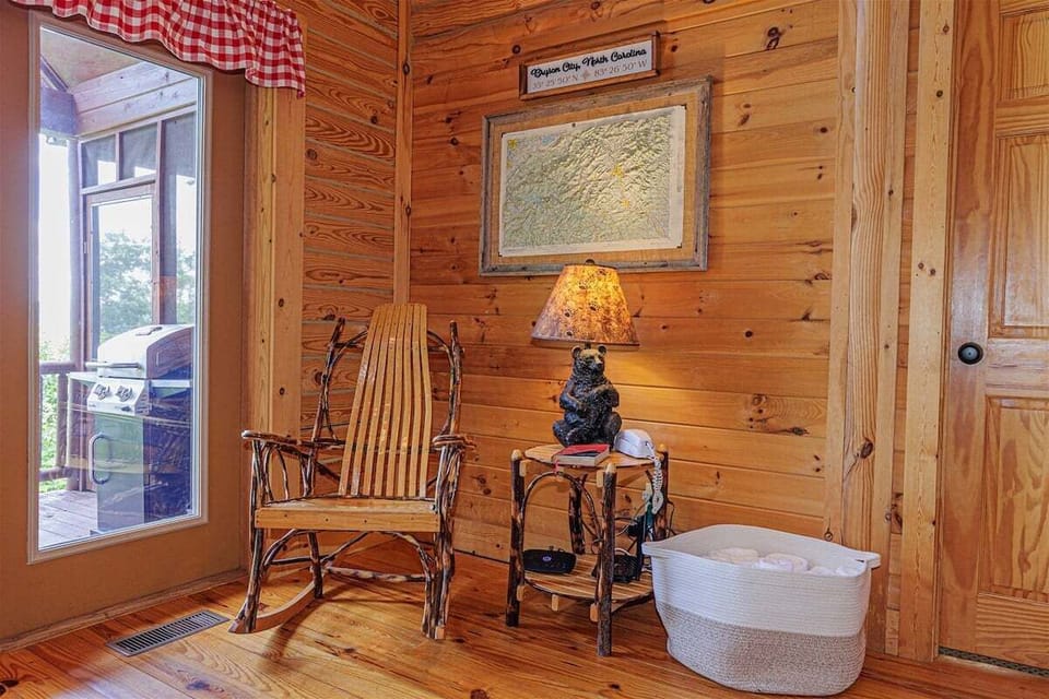 The cabin entryway features a  classic rocking chair inviting guests to settle in and kick off their boots.