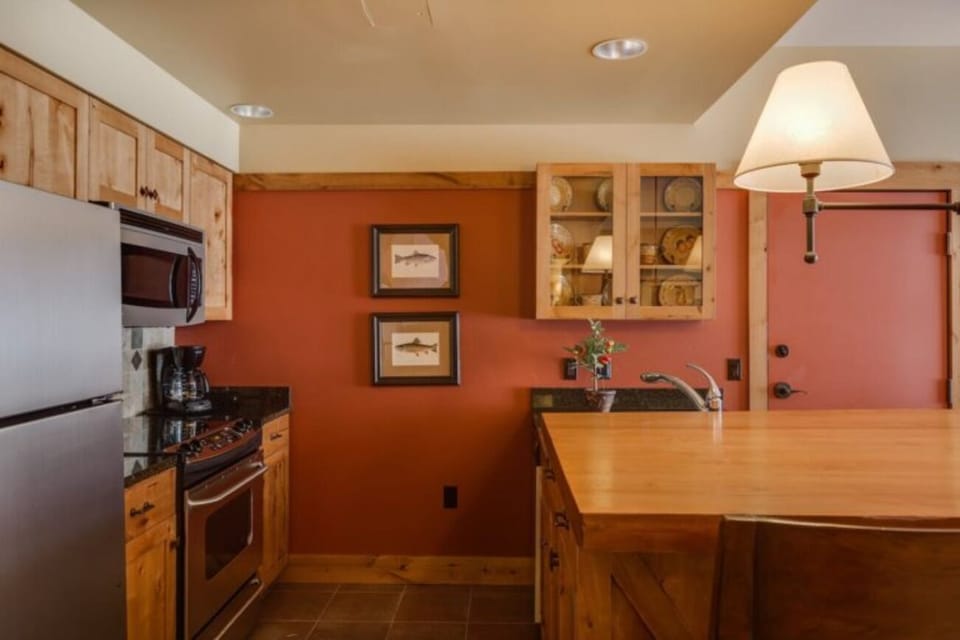 Gather for hearty meals around the rustic wood dining table.