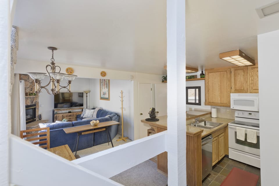 View from stairs looking into kitchen and living room