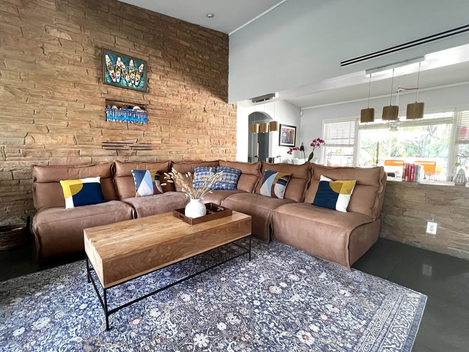Open concept living area with large open windows, smart tv, reclining sofa