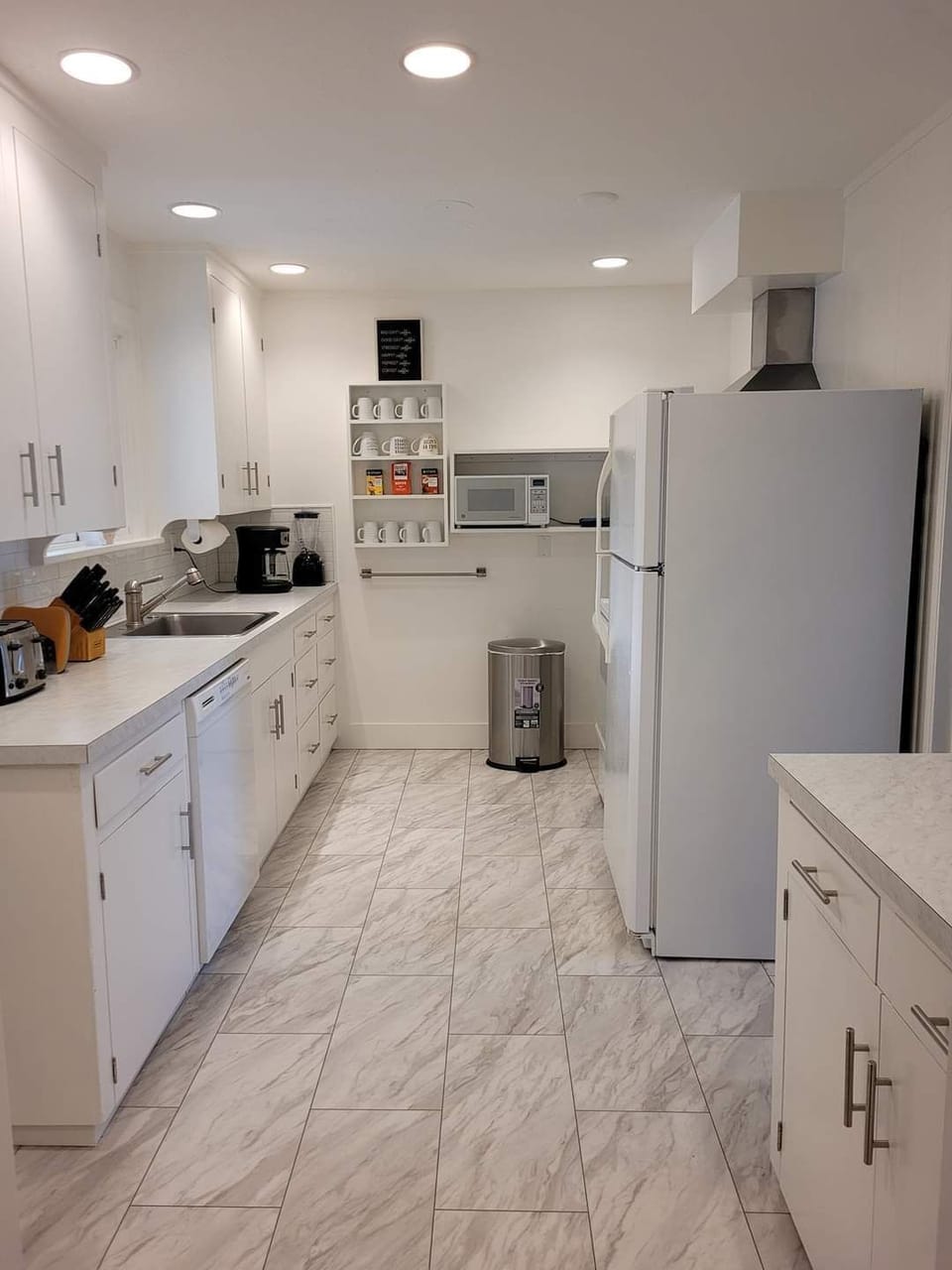 Galley kitchen, well appointed with ample dishes, silverware and cookware.