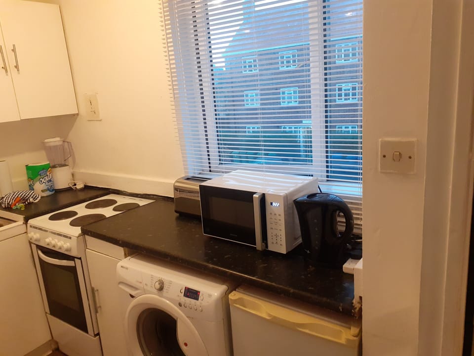 Kitchen with fridge freezer kettle and microwave 
