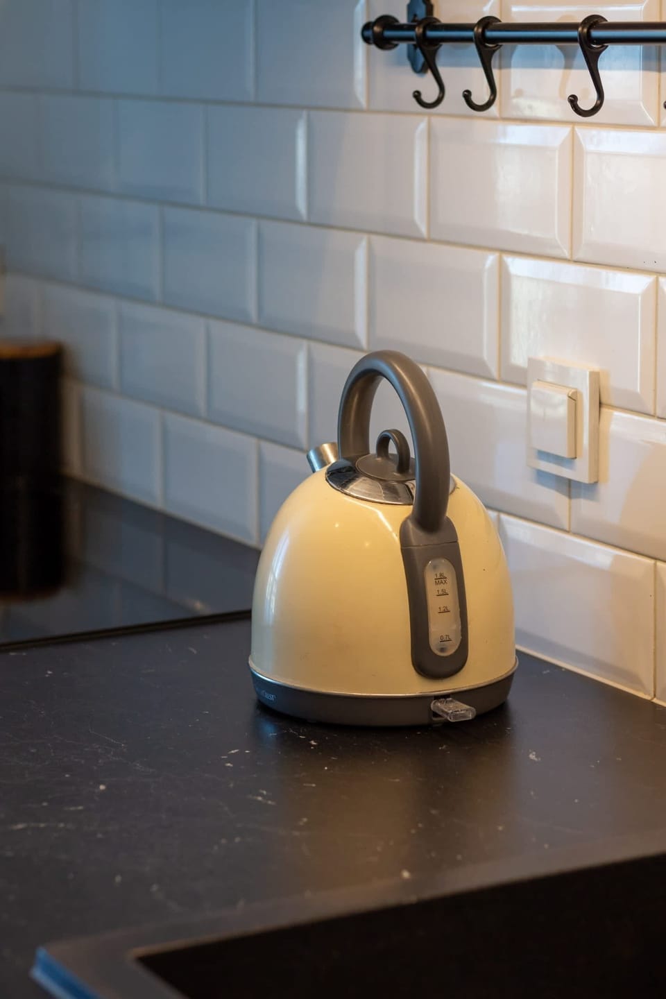 A close-up of the kitchen kettle on the counter, highlighting the stylish yet functional appliances.