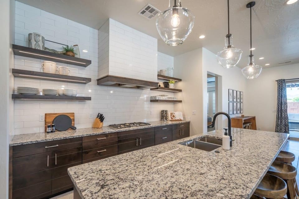 Beautiful chef's kitchen with ample cooking utensils and appliances