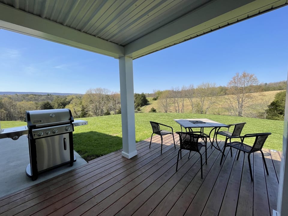 Spacious wrap-around deck with grill, fire-table, table and chairs.