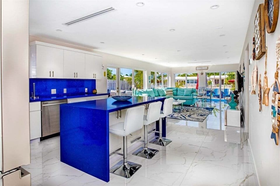 Bold blue countertops and an open layout create a vibrant gathering space at the heart of the home.