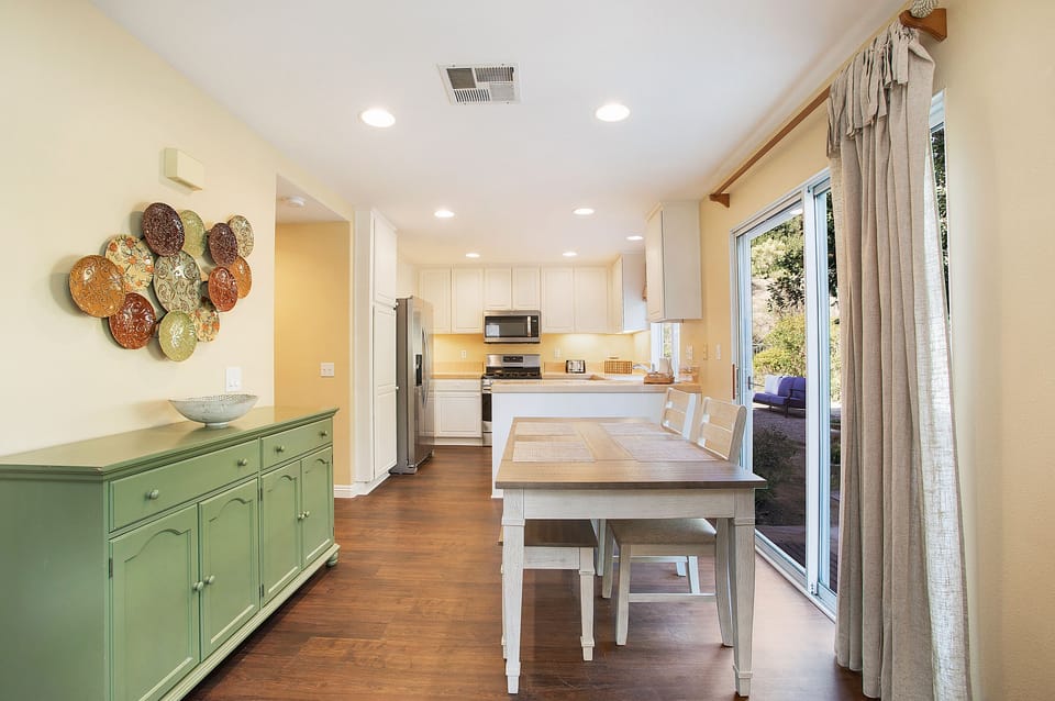 Gather for a meal or a board game in the sunlit dining area--table seats six.