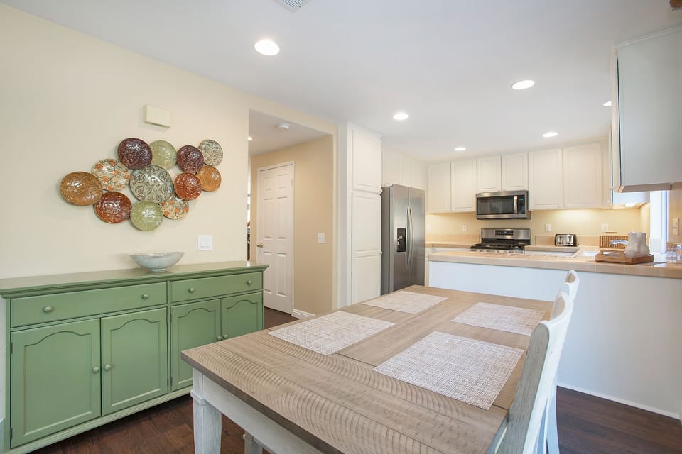 Gather for a meal or a board game in the sunlit dining area--table seats six.