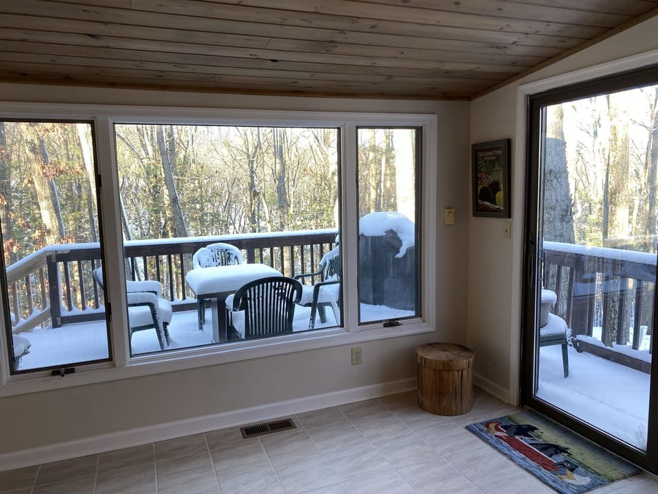 Sunroom spans the entire length of the back of the house overlooking the deck.