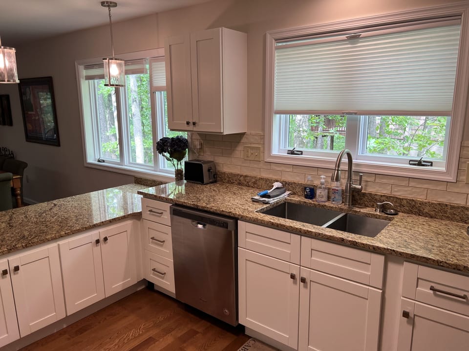 Kitchen with plenty of granite counter space and natural light.
