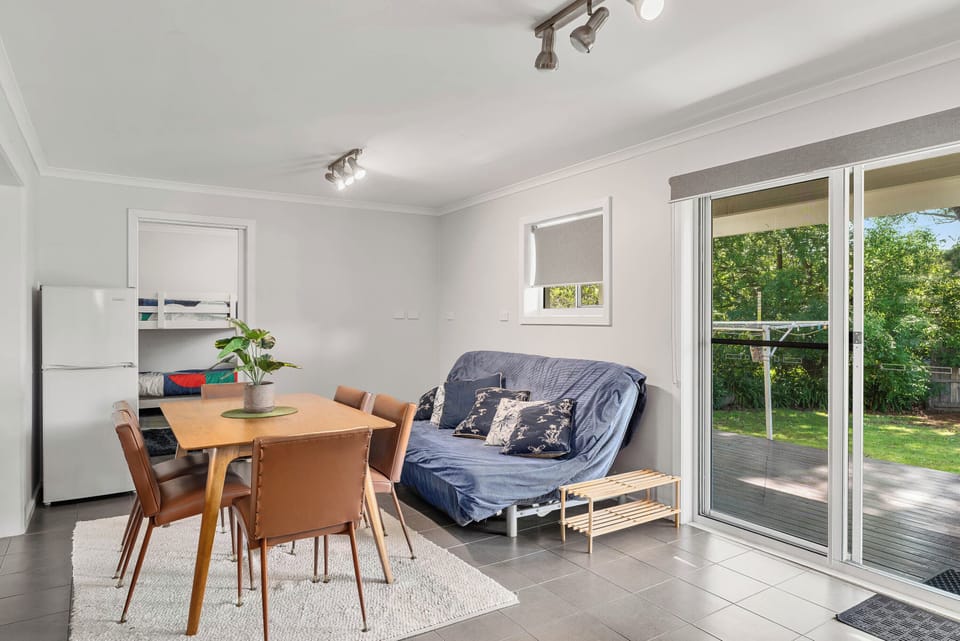 Bright and spacious living area with sofa bed
