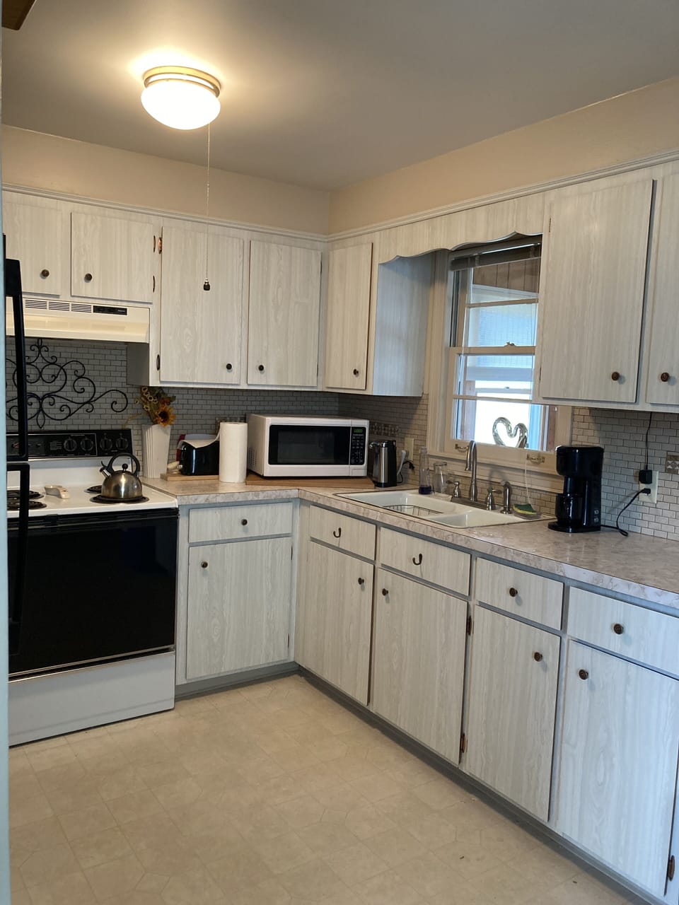 Electric Stove, new fridge, microwave, krueg coffee maker, electric can opener.
