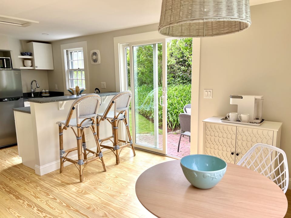 New kitchen with granite countertop, dining space and additional sitting room.