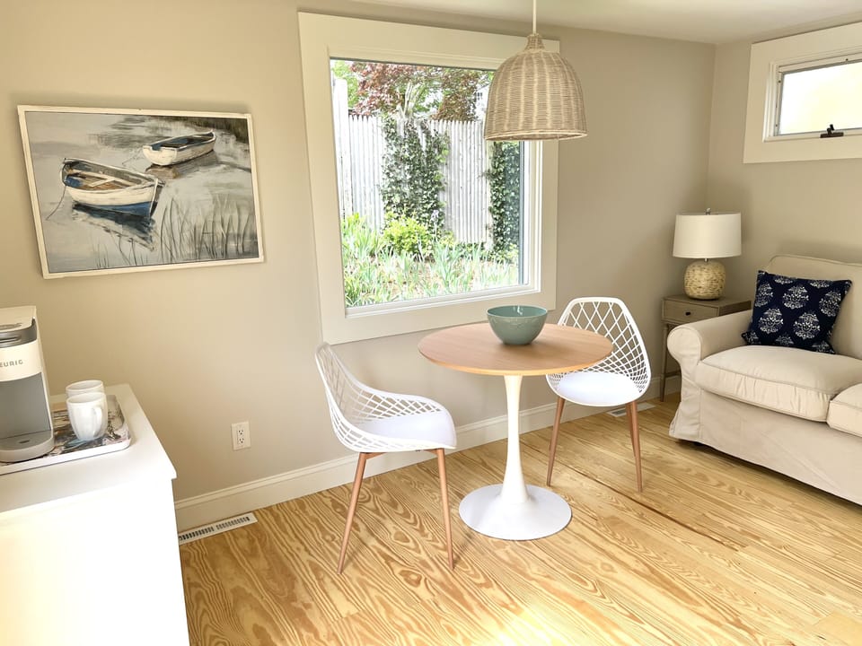 Cafe dining table and additional sitting area with sliding door to private patio