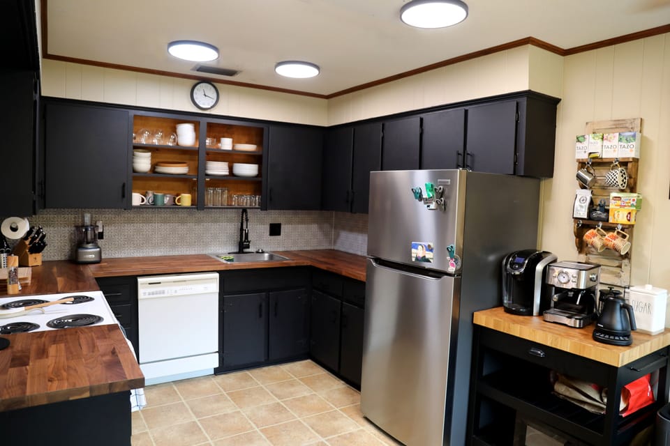 Kitchen equipped with major appliances and a well stocked coffee & tea station.