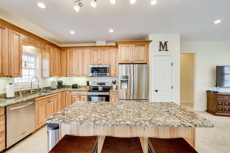 large center island with 3 bar stools.