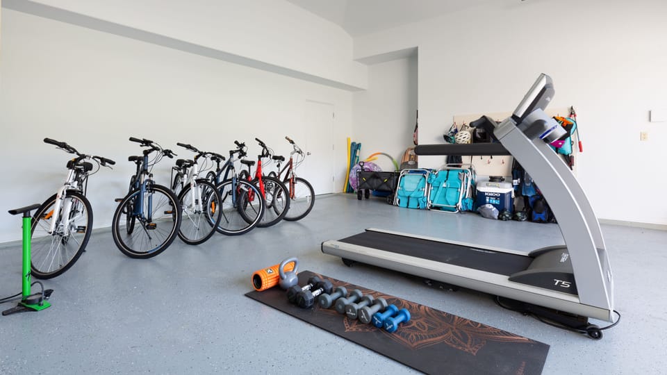Garage with beach gear and bikes.   Treadmill and weights.