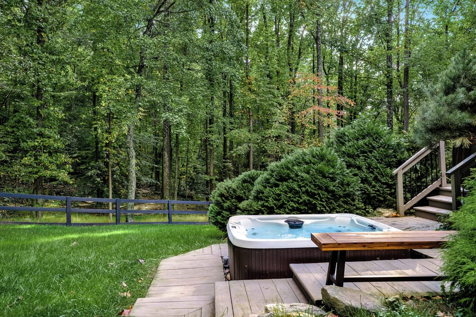 The hot tub is located off the patio of the master bedroom. 