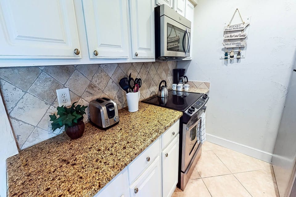 Updated kitchen is stocked with dishes, bowls and most everything you need for basic meal preparation.
