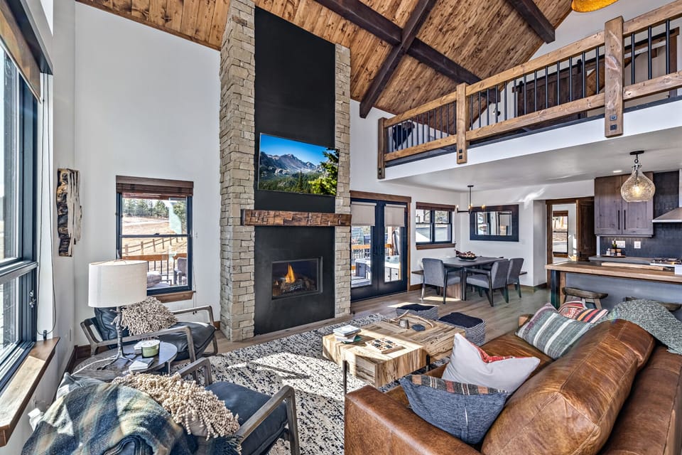 Cozy living area with 25 foot tall fireplace and 50 inch smart TV