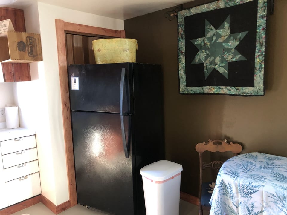 Kitchen has a full size refrigerator 