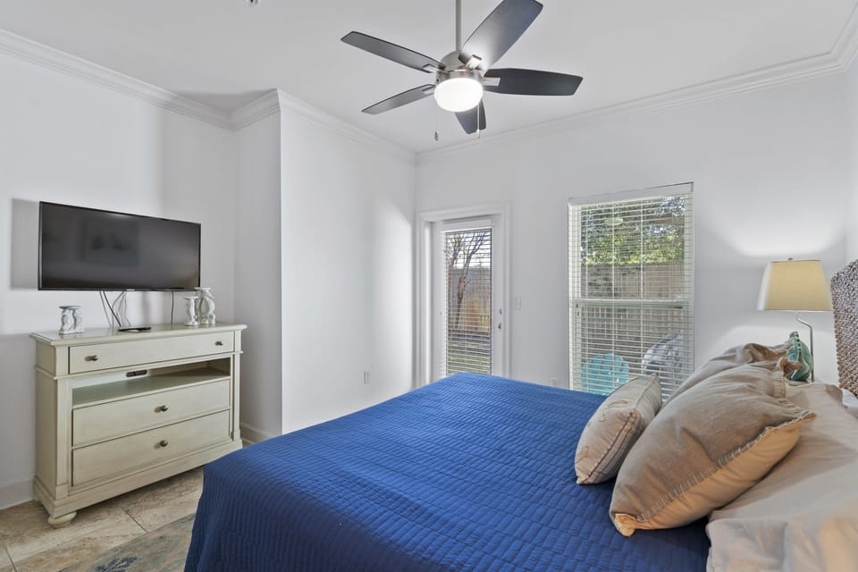 4th bedroom is downstairs with king bed and patio access