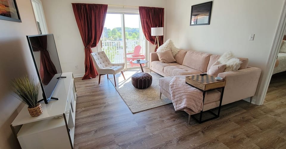 Family room with large TV leading out to private screened patio.