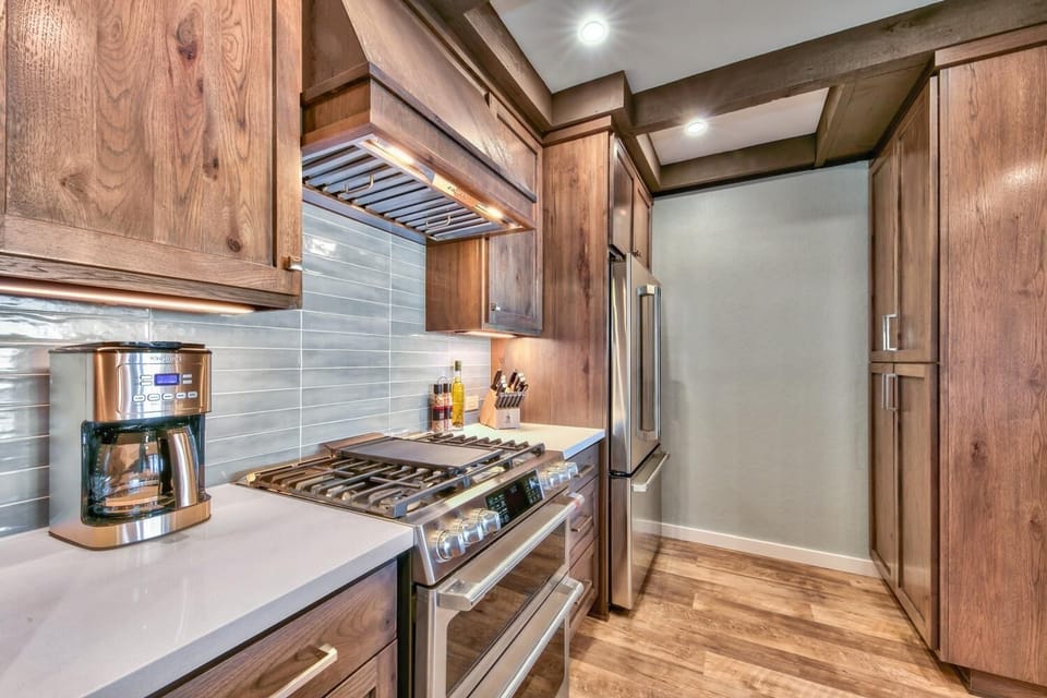 Step into your gourmet kitchen with rich wood cabinetry, professional-grade appliances, and elegant details that make cooking a pleasure.