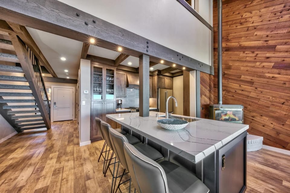 Your gourmet kitchen features marble countertops, exposed beams, and modern appliances where you'll create memorable meals in rustic elegance.