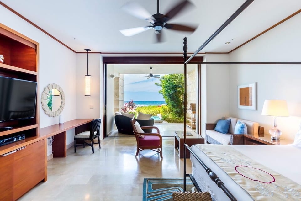 Master's BR is furnished with a wall unit with a flat-screen TV and sound system
