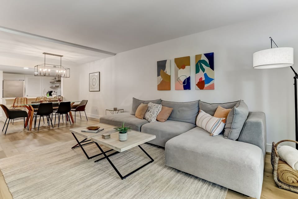 Spacious Living Area with a Flat Screen Smart TV, Shiplapped Walls, and a Gorgeous View of the Pool and Pond