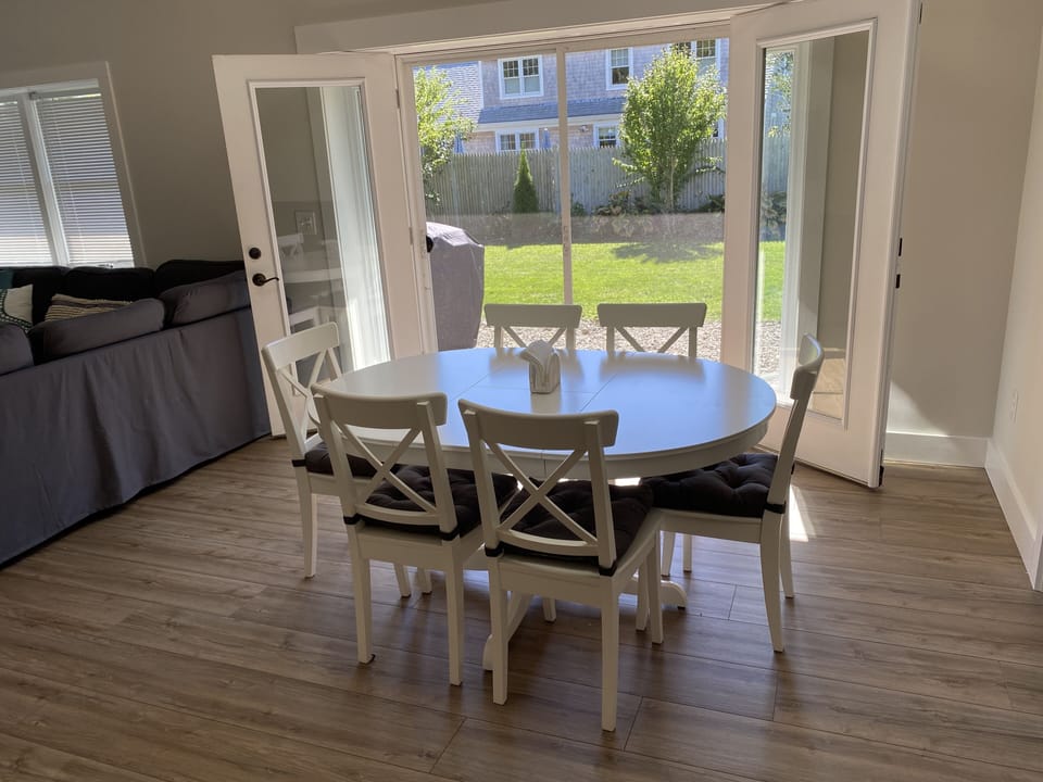 Open concept dining table & French doors to the back yard
