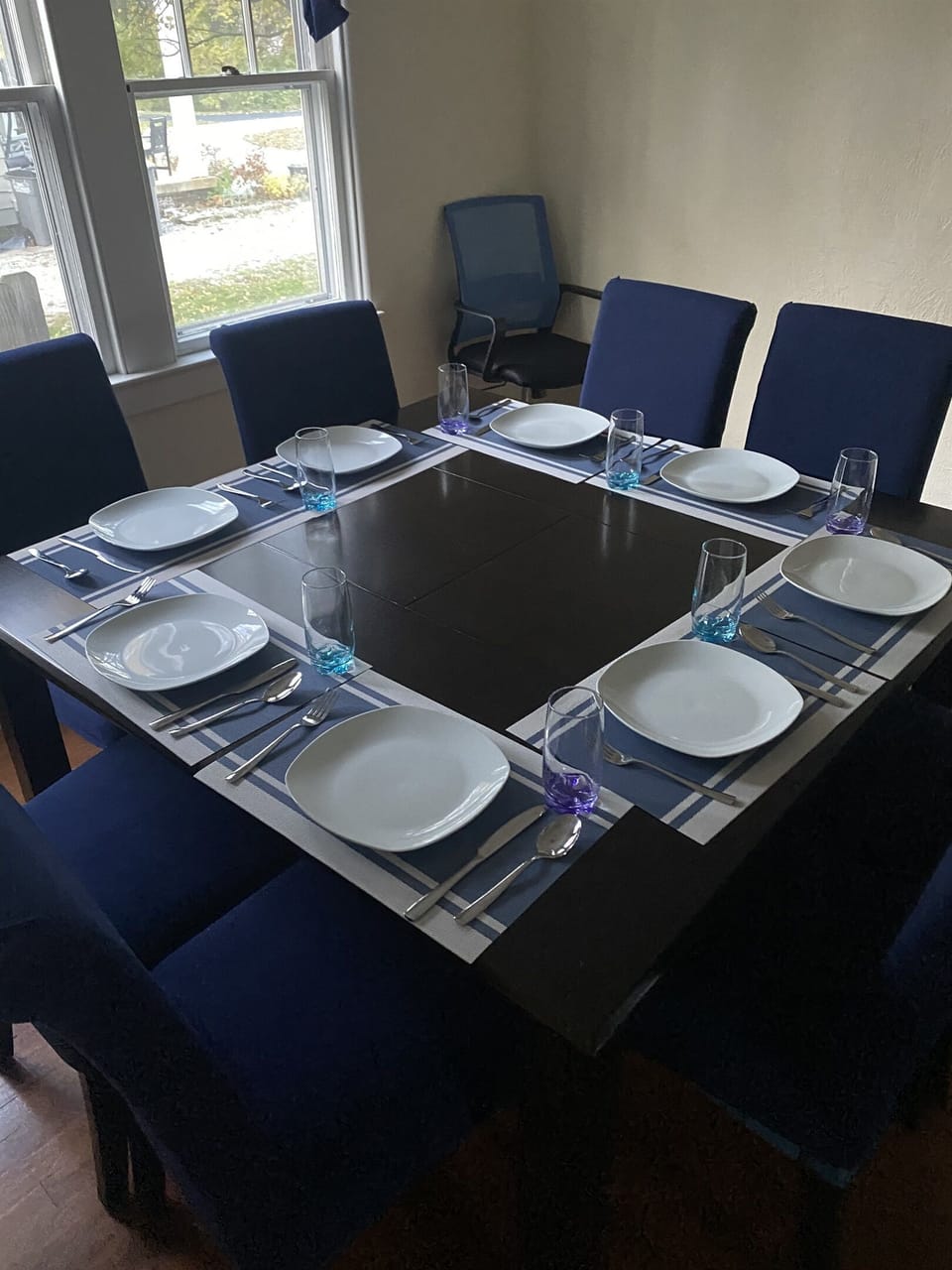 Dining Room shown with back to the Kitchen showing black out curtains